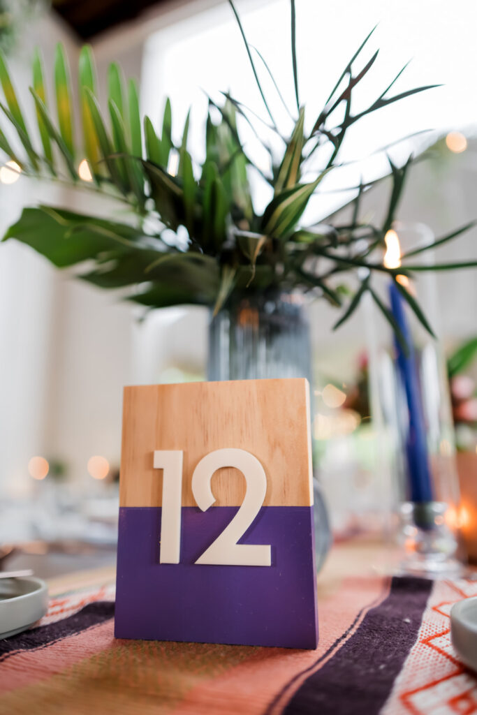 Color-block wooden table numbers with acrylic numbers created by Mittens and Lakes for Anne Marie and Eric’s wedding.”