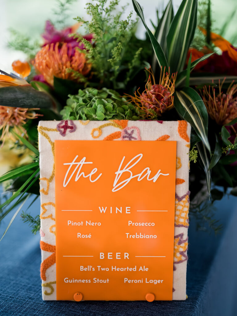 Wedding bar sign using the same handwoven fabric from the invitations, combined with acrylic details.